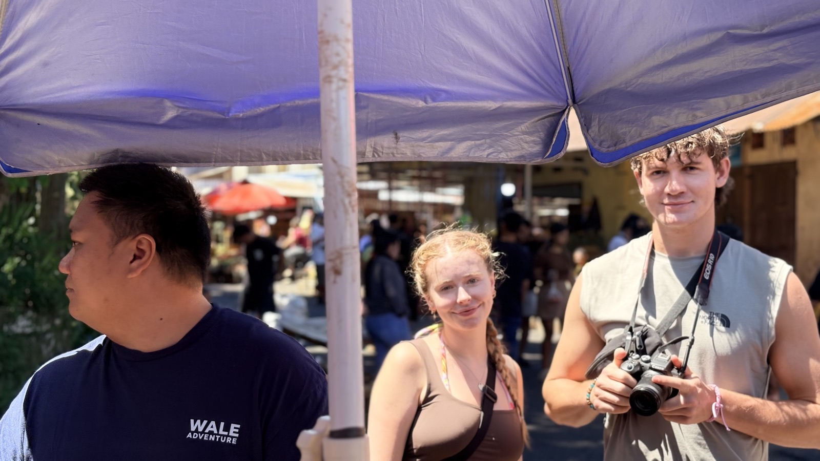Travellers and their Wale Adventure guide at Tomohon market